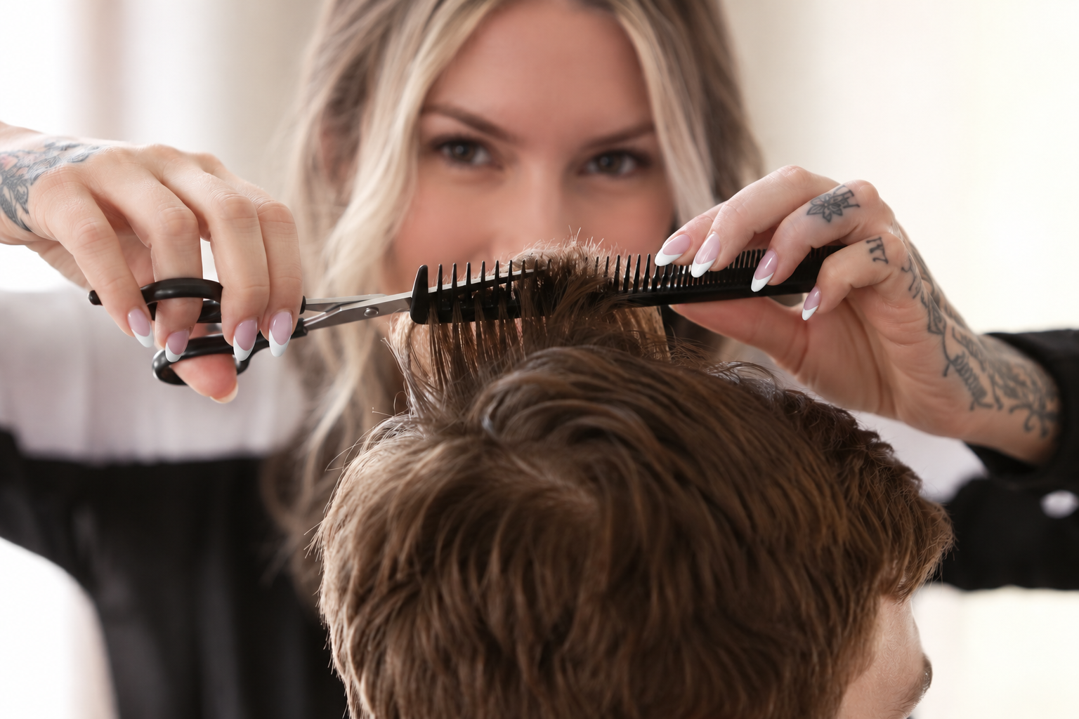 Barber finishing a fade at The Bedford Barber in Bedford, NS